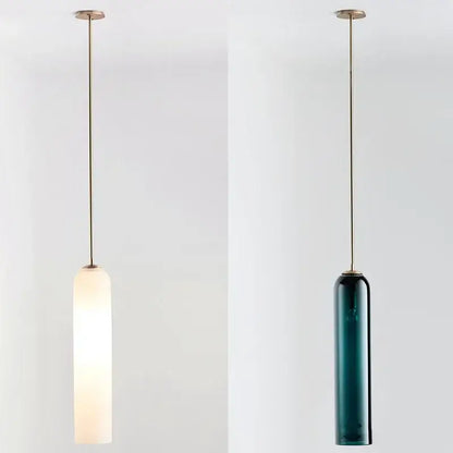 Two minimalist pendant lights with frosted white and deep teal led green glass shades from decorbites led green collection