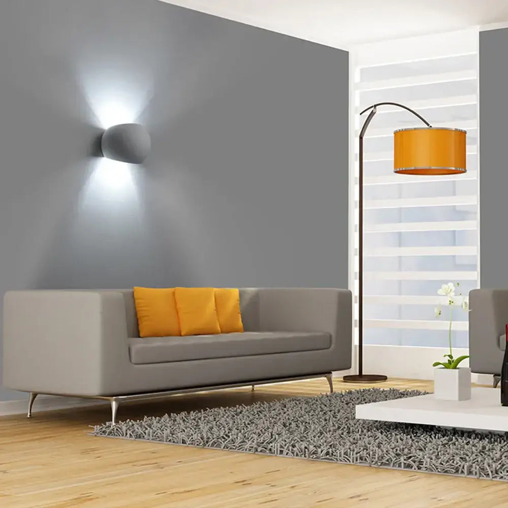 Gray modern sofa with orange throw pillows next to decorbites led gypsum wall lamp 5w modern indoor sconce lighting