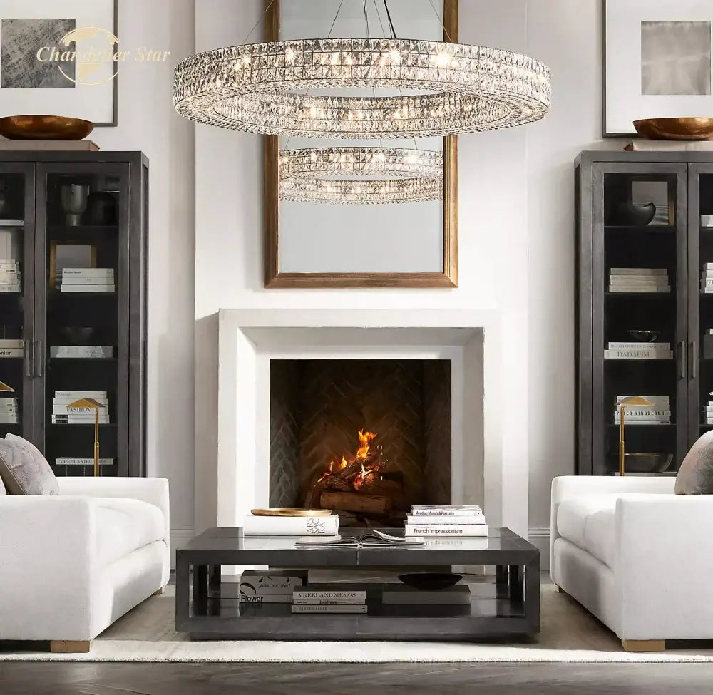 A multi-tiered decorbites led halo crystal chandelier with circular design hangs above a fireplace for modern decor