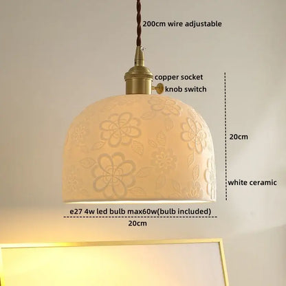 A cream ceramic decorbites led hanging lamp with floral embossing and brass-finished copper socket for living room