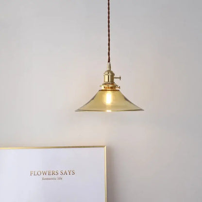 A warm brass decorbites led hanging lamp with conical glass shade and braided cord for bedroom and living room