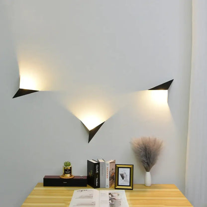 Black geometric decorbites led indoor wall lamp with angular triangular design emitting warm light for home decor