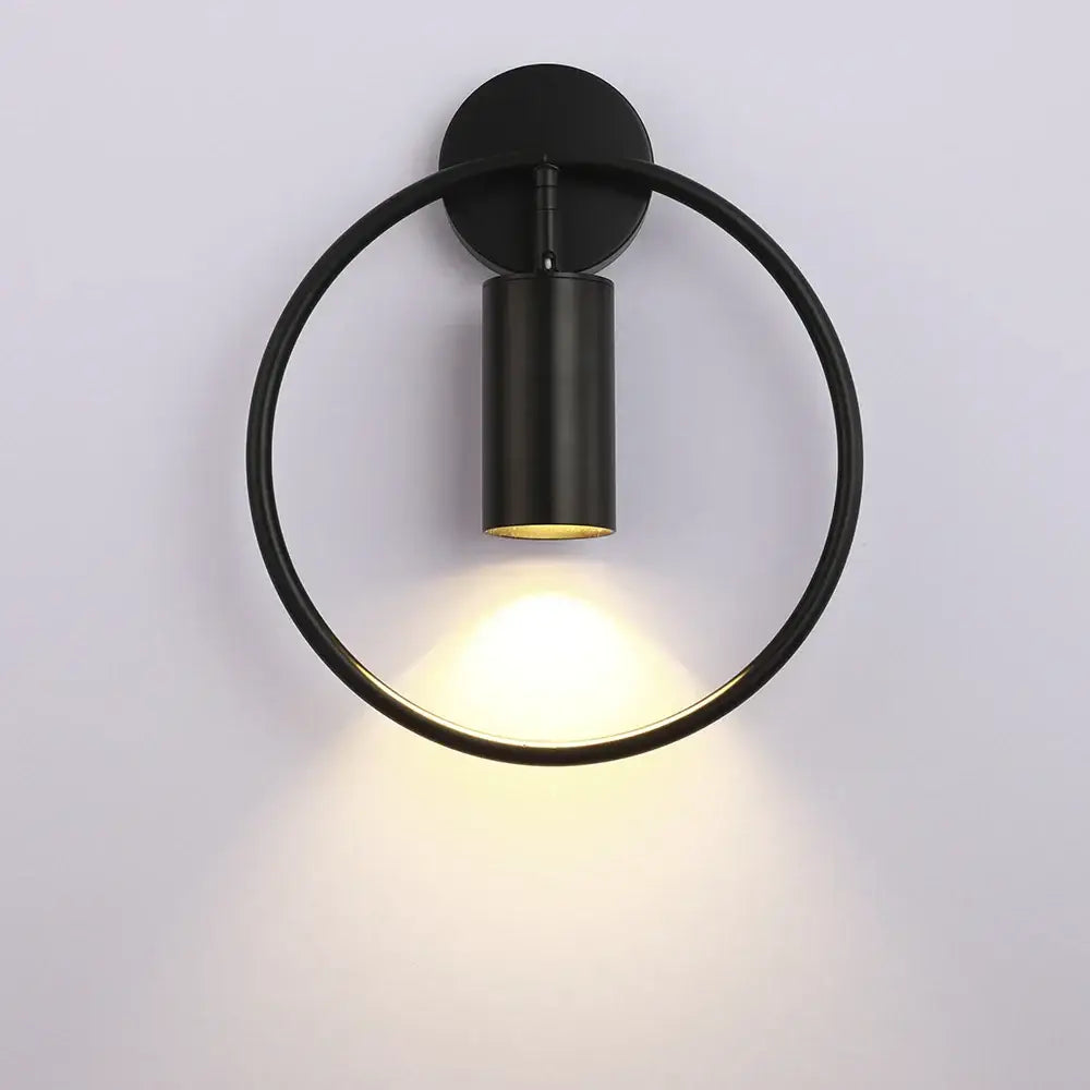 Black circular wall lamp with matte finish and warm focused light from DecorBites™ LED indoor wall lamps for home decor