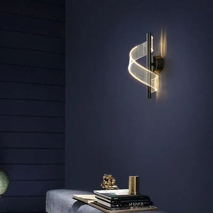 DecorBites™ LED indoor wall sconce light with a twisted illuminated mesh band in warm gold and matte black base