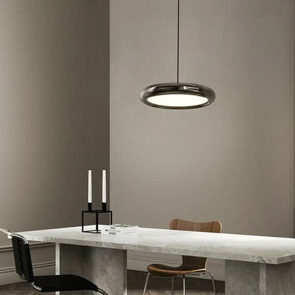 Modern black decorbites led iron pendant light with sleek circular design and frosted glass diffuser for home decor