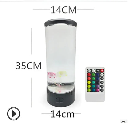 A 35cm tall decorbites led jellyfish lamp with transparent cylinder, black base, floating pink and green elements