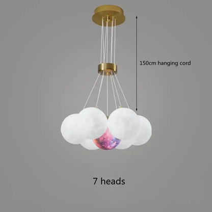 A modern DecorBites LED Lunar ceiling chandelier with gold metal frame and seven glass orbs including galaxy orb for home decor