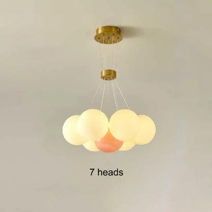 Gold-finished DecorBites LED Lunar ceiling chandelier with seven frosted glass orbs for elegant home decor lighting