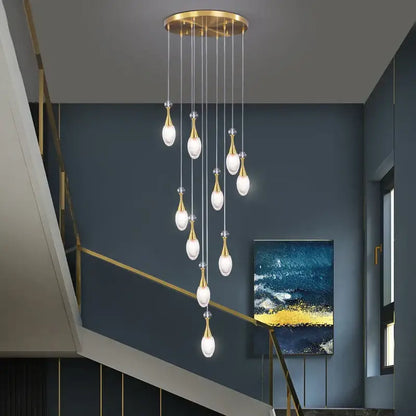 Gold-toned decorbites led luxury chandelier with teardrop glass bulbs hanging from brass fixture for living room lighting