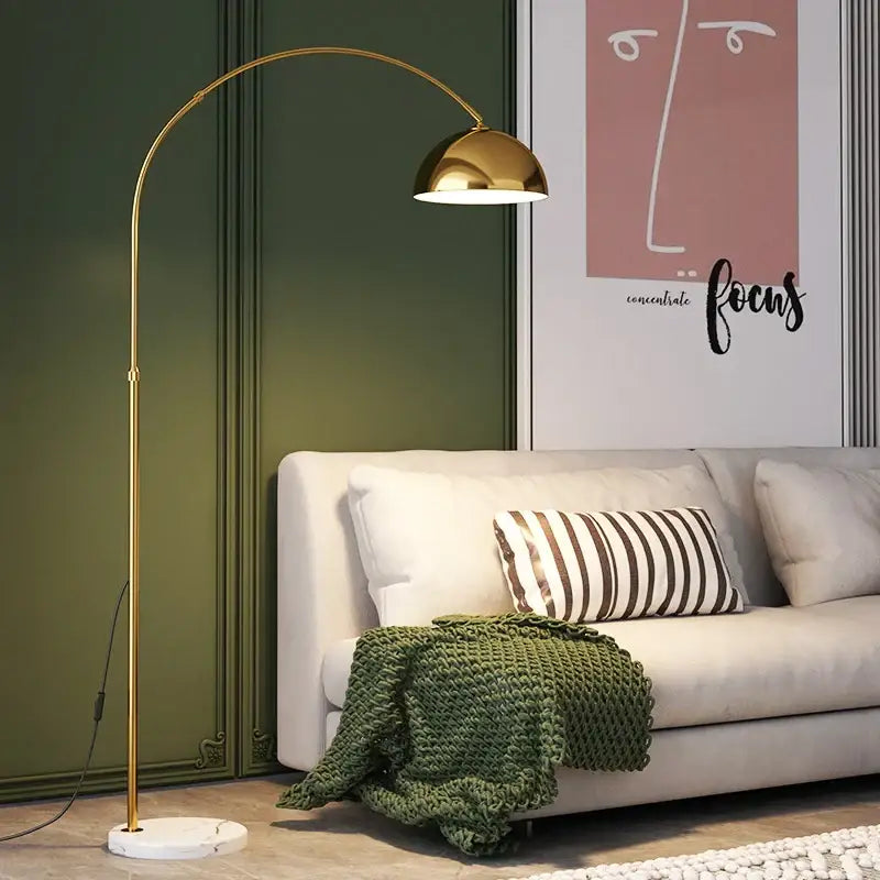 Gold-toned DecorBites LED marble base floor lamp with arched design and polished dome shade for modern living spaces