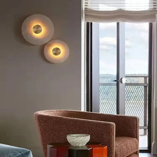 Two DecorBites™ LED marble brass wall sconces with frosted glass shades and warm glow for parlor and aisle lighting