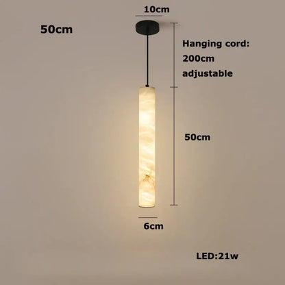 A warm cylindrical led marble hanging lamp in white alabaster with a soft glowing illumination by decorbites