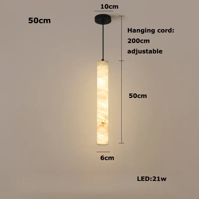 A warm cylindrical led marble hanging lamp in white alabaster with a soft glowing illumination by decorbites