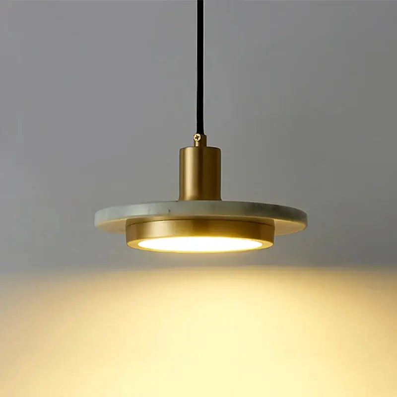 A DecorBites led marble pendant light with brass frame warm glow and white marble disc for dining and bedroom decor