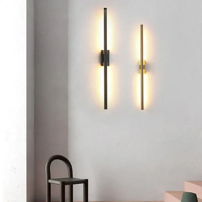 Two modern minimalist wall lamps by decorbites led metal tube in matte black and brushed gold with warm lighting