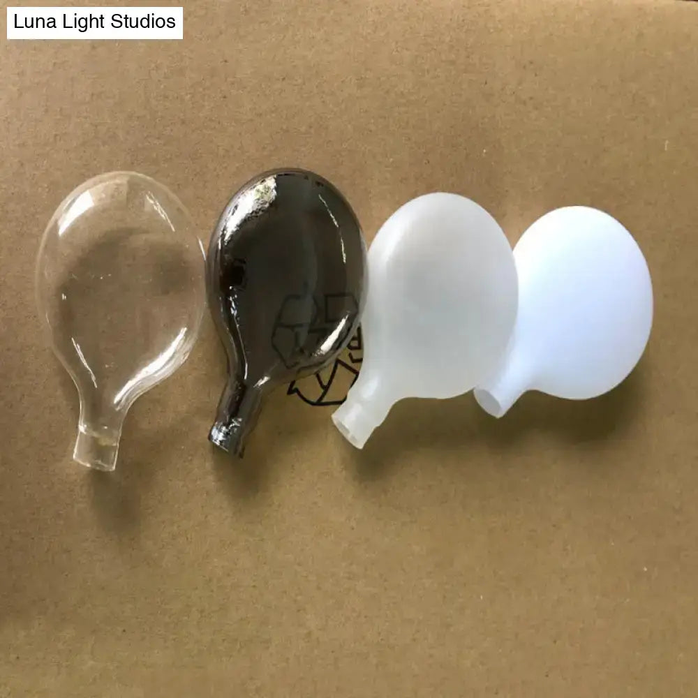 DecorBites™ ceiling light with clear black and white translucent glass bulbs on a metallic gold tree branch for dining room