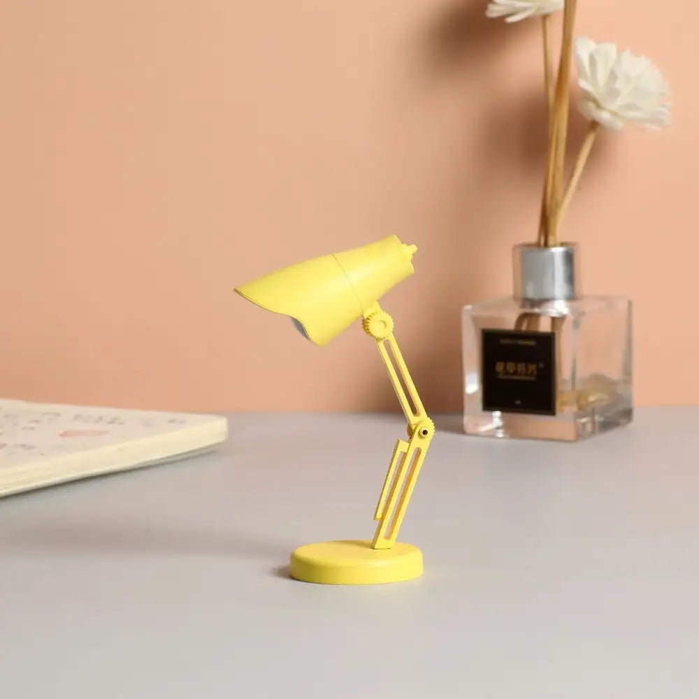 A bright yellow DecorBites LED mini desk lamp with flexible arm and magnetic base ideal as a night light for study