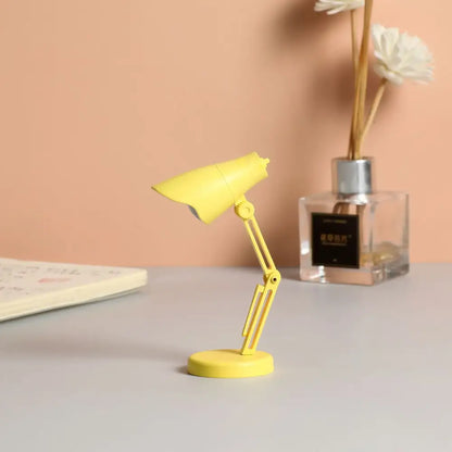 A bright yellow DecorBites LED mini desk lamp with flexible arm and magnetic base ideal as a night light for study