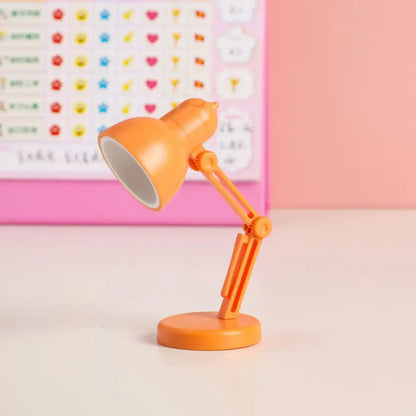 Orange plastic decorbites led mini desk lamp with adjustable arm and circular magnetic base for study and bedroom use