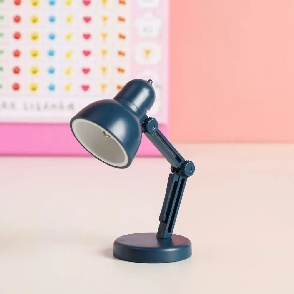 A navy blue decorbites led mini desk lamp with adjustable arm, matte metal body, and eye protection for study and bedroom