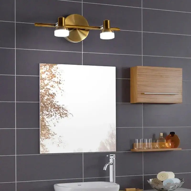 Gold-toned decorbites led mirror wall lamp with two cylindrical bulbs and circular base for bathroom or bedroom use