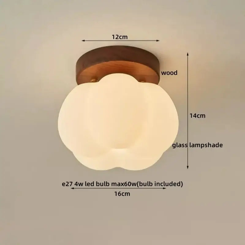 A decorbites led modern ceiling light with a soft off-white glass cloud-shaped lampshade on a dark wood base