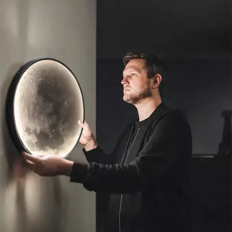 Circular black-framed decorbites led moon wall lamp with textured moon-like surface for modern bedroom decor lighting