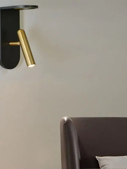 A sleek black and gold DecorBites LED Nordic wall lamp with a cylindrical brass head for wall atmosphere decoration