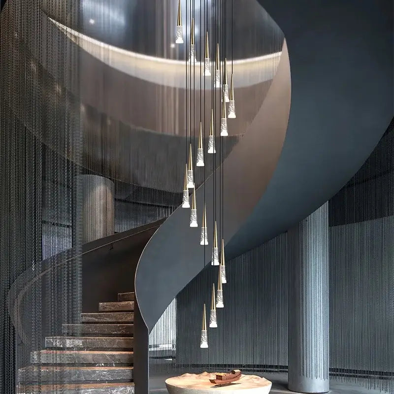 Modern spiral staircase with marble steps and metallic railings illuminated by decorbites led nordic staircase chandelier