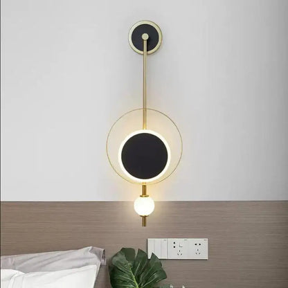 Modern gold-toned decorbites led nordic wall lights with circular black illuminated face and spherical bulb for indoor decor