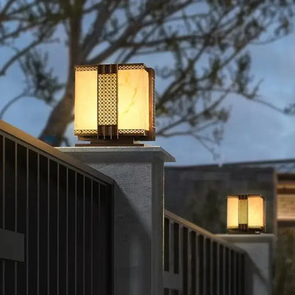Warm-toned decorbites led outdoor street lamp with golden metal frame and intricate lattice for pillar fence lighting