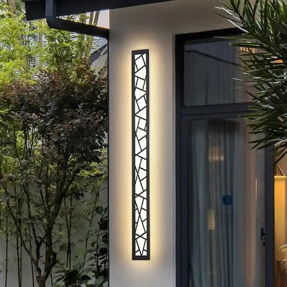 Modern black-framed DecorBites™ outdoor wall lamp with geometric glass panels and warm LED light for villa porch use