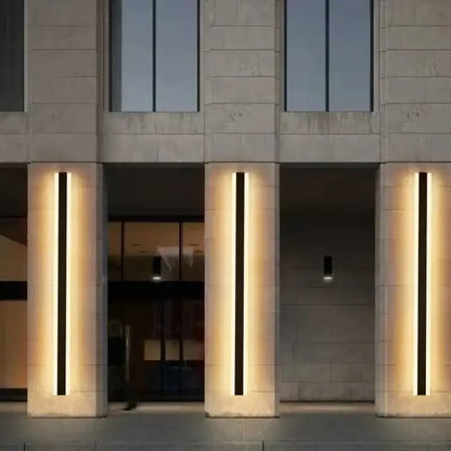 Modern minimalist decorbites™ led outdoor wall lamp with black and amber vertical strips mounted on stone pillars