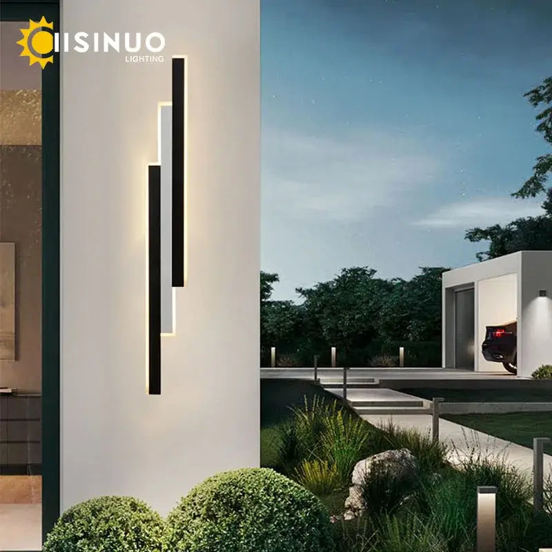 Modern minimalist decorbites led outdoor wall lantern with black and white bars emitting warm glow for porch lighting