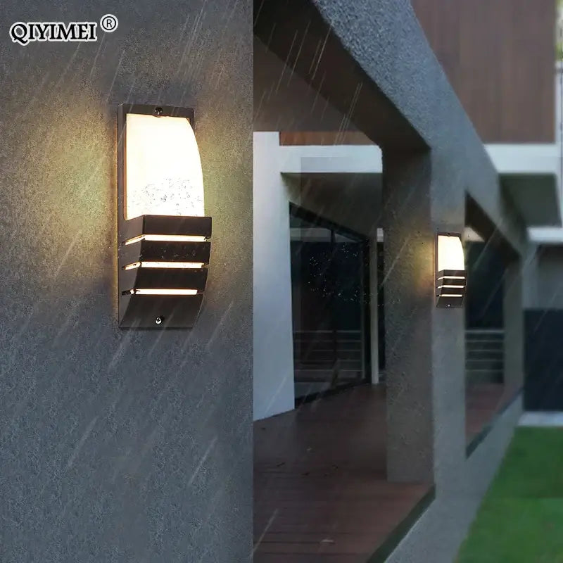 Modern black metal decorbites led outdoor wall sconce with frosted glass diffuser and horizontal slats emitting warm light