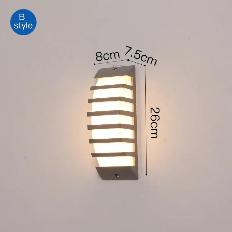 Modern gray metal DecorBites LED outdoor wall sconce with horizontal slats emitting warm light for patio use