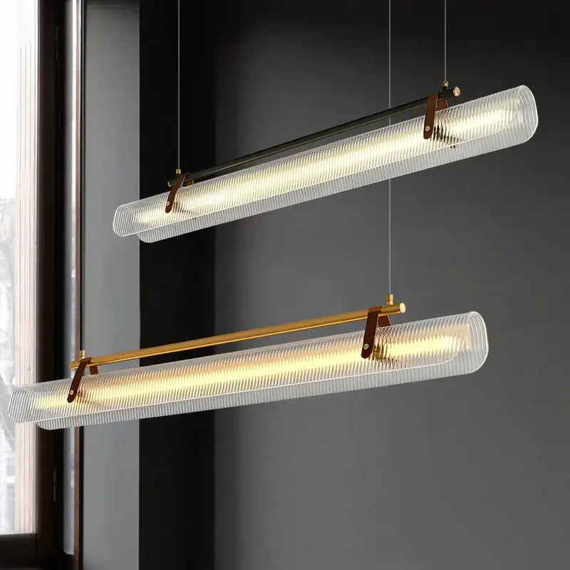 Two modern decorbites led pendant lamps with textured glass shades and brass accents for dining and living rooms