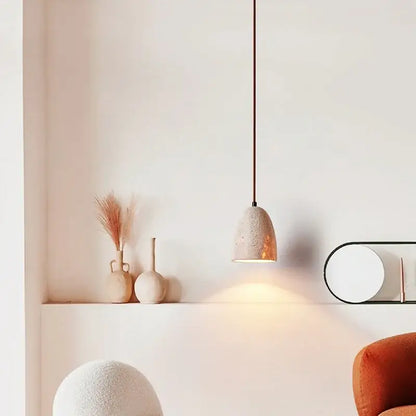 A warm-toned yellow travertine pendant lamp with textured concrete shade and slender black cord by decorbites led pendant