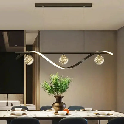 Modern black metal decorbites led pendant with three spherical glass globes emitting warm sparkling led light for dining room