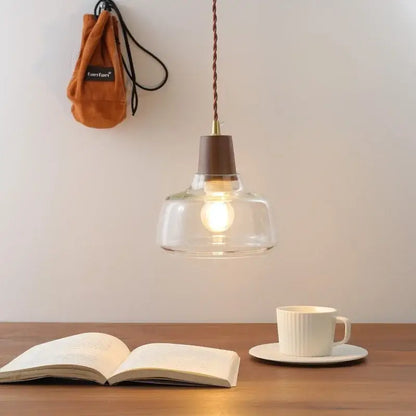 Clear glass pendant lamp with brown wooden top and twisted copper cord from decorbites led pendant collection