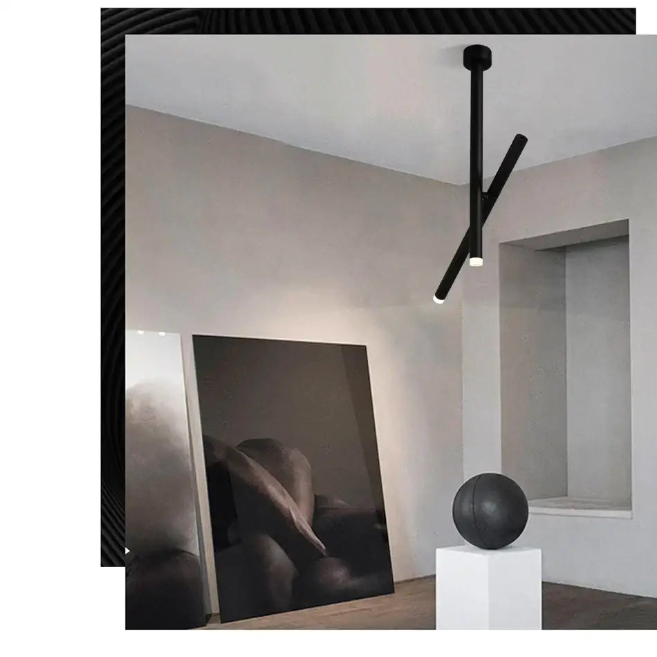 Black minimalist decorbites led pendant light with two intersecting cylindrical arms for living room ceiling use