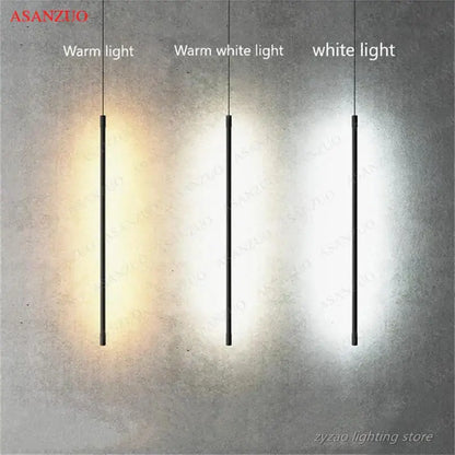 Three slim black pendant lights from decorbites™ with adjustable line strip emit warm, warm white, and white light