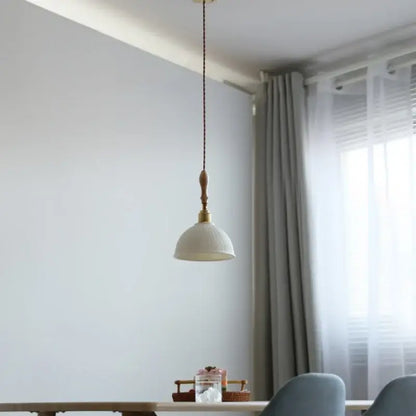 DecorBites led pendant light with white textured ceramic shade, brass fixture, and ash wood accent in Japanese style design