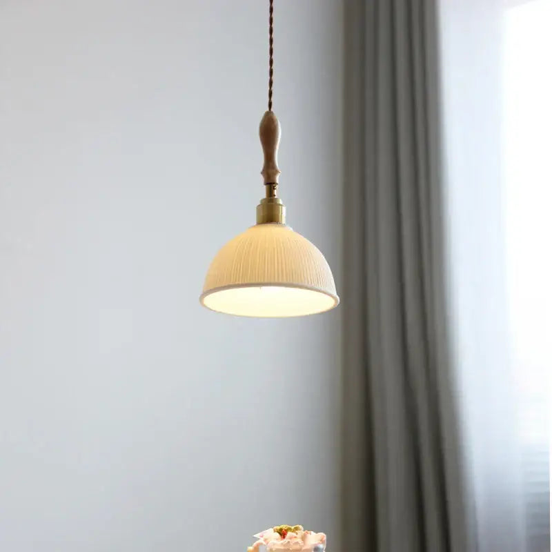 Warm-toned white ceramic decorbites led pendant light with ribbed texture wooden handle and brass accents for hanging use