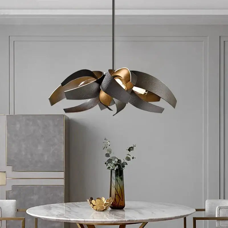Modern pendant light with sculpted layered metal petals in brushed gold and matte black finish by decorbites led pendant