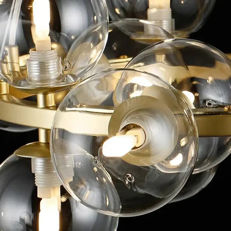 Gold-toned decorbites led pendant light chandelier with frosted glass spheres suspended from brass fixture for modern decor