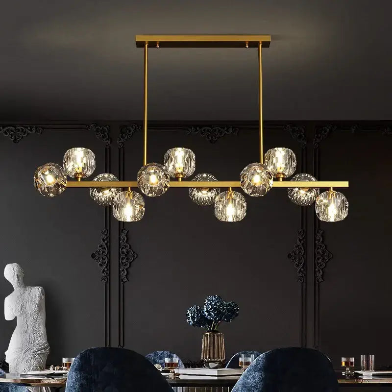 Gold-toned decorbites led pendant light chandelier with faceted crystal globes suspended on a sleek bar for modern decor