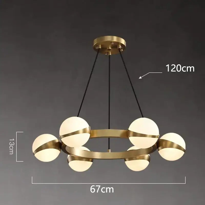 Modern brass decorbites led pendant lights with six frosted glass globes suspended by black cords for indoor lighting