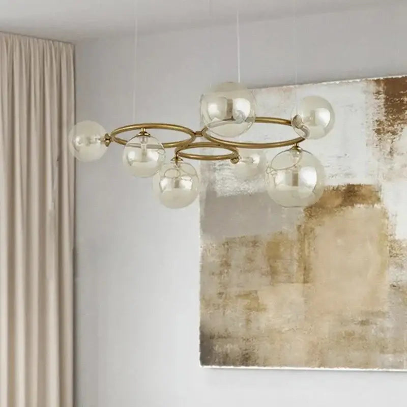 Modern brass DecorBites led pendant chandelier with clear glass globe shades for indoor lighting and modern home decor