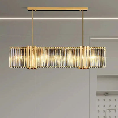 Gold-toned decorbites led pendant light chandelier with vertical crystal rods and warm glowing lights for modern decor